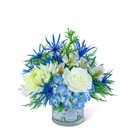 Blue and white floral arrangement in a glass vase