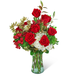 Bouquet of red roses and white flowers in a clear glass vase