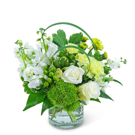 White and yellow floral arrangement in a glass vase