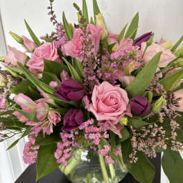 Pink and purple mixed bouquet in a clear glass vase