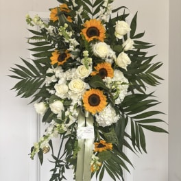Standing floral spray with sunflowers and white roses on an easel