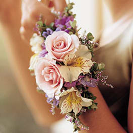 Pink rose wrist corsage with small purple and cream flowers