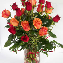 Bouquet of red and orange roses in a clear glass vase