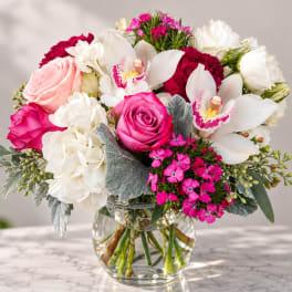 Pink and white mixed bouquet in a clear glass vase