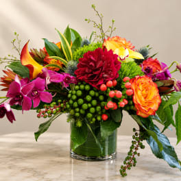 Colorful mixed flower arrangement in a clear glass vase