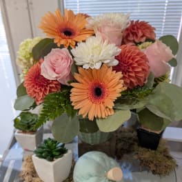 Bouquet of pink roses, orange gerberas, and white mums in a vase