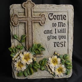 Stone plaque with a cross, flowers, and the words "Come to me and I will give you rest"