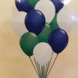 Cluster of blue, green, and white balloons tied together