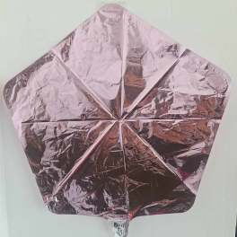 Pink metallic star-shaped foil balloon on a plain background