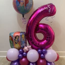 Princess-themed balloon arrangement with a large pink number 6 balloon