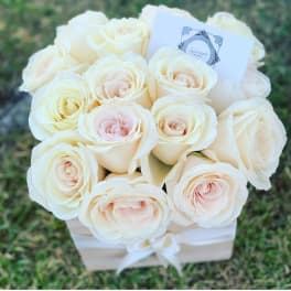 Bouquet of cream and blush roses in a white box with a ribbon