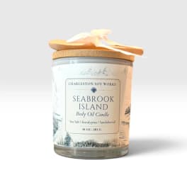 Glass jar candle with a wooden lid and ribbon bow