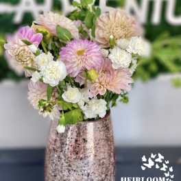 Pink and white flowers arranged in a metallic vase