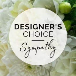 White floral arrangement with a sympathy label