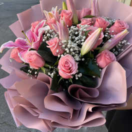 Pink roses and lilies in pastel pink wrapping