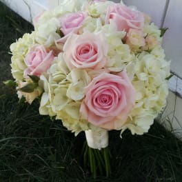 Pink roses and cream hydrangeas in a hand-tied bouquet
