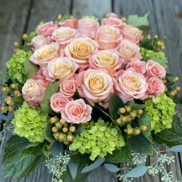 Bouquet of pale pink and peach roses with green hydrangeas