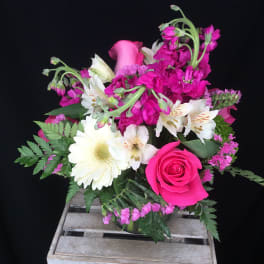 Pink and white mixed flower bouquet in a glass vase