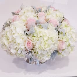 Pink roses and white hydrangeas in a silver vase