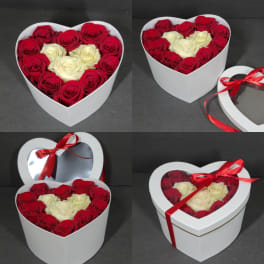 Heart-shaped boxes filled with red and white roses