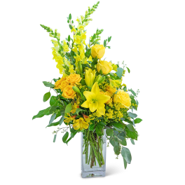 Yellow floral arrangement in a clear glass vase