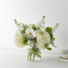 White floral arrangement in a clear glass vase