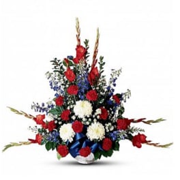 Tall red, white, and blue floral arrangement in a vase