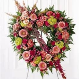 Heart-shaped floral standing spray with pink and red blooms