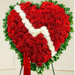 Heart-shaped red floral wreath with a white diagonal ribbon and green border