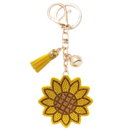 Sunflower-shaped keychain with a yellow tassel and bell