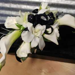 White calla lilies and orchids with a black ribbon