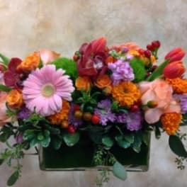 Mixed bouquet in a rectangular vase with pink and orange flowers