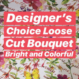 Floral-patterned wrapping paper with bold text reading Designer's Choice Loose Cut Bouquet