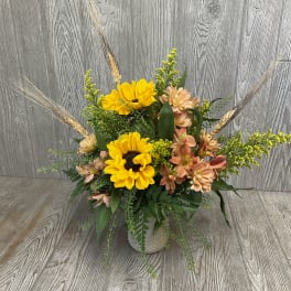 Sunflower and peach flower arrangement in a white vase
