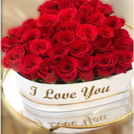 Heart-shaped box filled with red roses and I Love You text in gold script