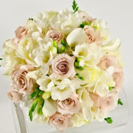 Bouquet of cream and blush flowers with green accents