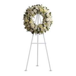 White floral wreath on a standing easel
