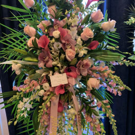 Tall pink and white floral standing arrangement with orchids and roses