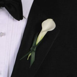 White calla lily boutonniere on a black suit jacket