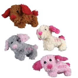 Four plush dog toys in different colors on a white background