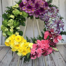 Colorful floral wreath with pink, purple, yellow, and green blooms