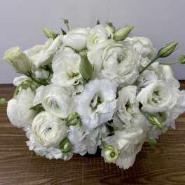White floral bouquet with layered blooms and green buds