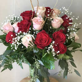 Bouquet of red and pale pink roses in a glass vase