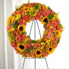 Autumn floral wreath on a black easel with sunflowers and roses