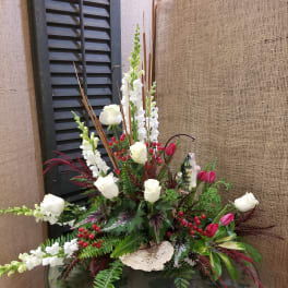 Tall floral arrangement with white roses, white snapdragons, and pink tulips