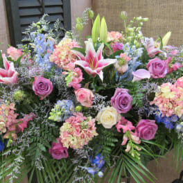 Large mixed floral arrangement with lilies, roses, and hydrangeas