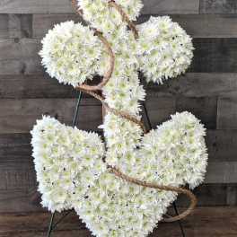 White floral anchor-shaped sympathy arrangement with rope on a stand