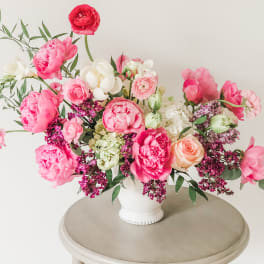 Pink and white floral arrangement in a white vase