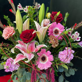Mixed bouquet with pink lilies, red roses, and pink gerbera daisies