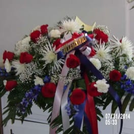 Large red, white, and blue floral spray with ribbons
